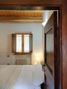 Un dormitorio con una cama grande y una ventana en Appartamento Sotto i Torricini, en Urbino