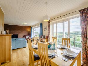 a dining room and living room with a table and chairs at 3 bed in Rothbury 63025 in Rothbury