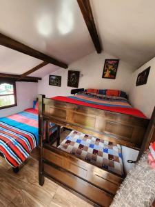 a bedroom with two beds in a room at Hospedaje Las Cabañas in Monguí