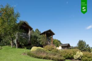 an image of a large house with trees at Hotel y Cabañas Punta Larga - Caja Los Andes in Frutillar