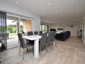 a dining room and living room with a table and chairs at 4 Bed in Oswestry 74110 in Kinnerley