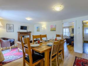 a dining room and living room with a table and chairs at 3 bed property in Bridport 75334 in Frome Vauchurch