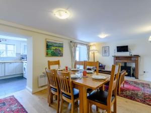 a kitchen and dining room with a wooden table and chairs at 3 bed property in Bridport 75334 in Frome Vauchurch