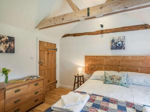 a bedroom with a large bed with a wooden headboard at 2 Bed in Beverley 75584 in Lund