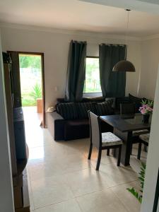 a living room with a couch and a table at Rancho próximo ao lago de furnas in Boa Esperança