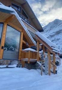 une cabane en rondins dans la neige avec un panneau devant dans l'établissement Hotel L'Edelweiss, à Pralognan-la-Vanoise