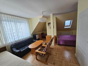 a living room with a table and a couch at Villa Krystyna in Dźwirzyno