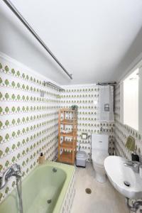 a bathroom with a tub and a sink and a toilet at Urban Apartment in the Heart of Athens in Athens