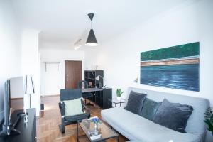 a living room with a couch and a desk at Urban Apartment in the Heart of Athens in Athens