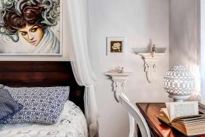 A bed or beds in a room at GOCCE VILLAS - Villa Partenope Spectacular Sea View