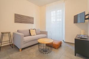 a living room with a couch and a table at Enchanted Como Lake - City Apartment by Rent All Como in Como