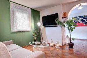 a living room with a couch and a table at Villa Islamorada Pool and Sea View in Massa Lubrense