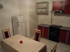 a kitchen with a table and a white refrigerator at Apartments Lička 25 in Split