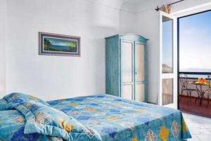 a bedroom with a bed and a view of the ocean at GOCCE VILLAS - Villa Nanà Pool With Amazing Sea View in Colli di Fontanelle +10 photos