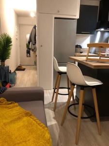 a kitchen with two chairs and a table in a room at Bienvenue chez Celia et Nicolas in Saint-Étienne-de-Tinée