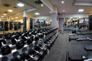 a gym with rows of dumbbells in a gym at MDR Studio Apartment Luxury pool, gym, parking, jacuzzi. in Los Angeles