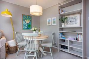 a dining room with a table and chairs at Western Court Sidmouth close to town and beach in Sidmouth