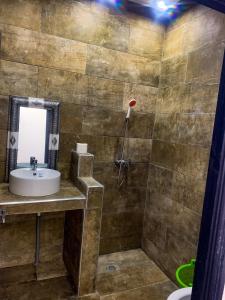 a bathroom with a sink and a shower at Equinox in Tan-Tan Plage +49 photos