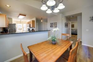 a kitchen and dining room with a wooden table and chairs at Updated Springs Home - 3 Mi to Garden of the Gods! in Colorado Springs