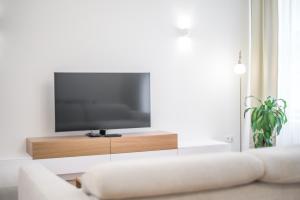 a living room with a flat screen tv on a entertainment center at Laurinska 1 Apartments in Bratislava