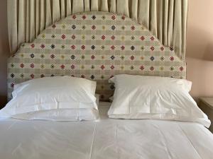 łóżko z dwoma poduszkami przed ścianą w obiekcie 1 Bed in Forres 78430 w mieście Forres