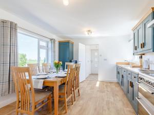 a kitchen and dining room with a table and chairs at 3 bed property in Bude 78213 in Ashwater