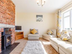 a living room with a couch and a fireplace at 3 bed property in Bude 78213 in Ashwater