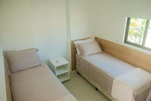 a small bedroom with a bed and a window at Na Morada dos Milagres, condomínio Morada do Toque in São Miguel dos Milagres +54 photos