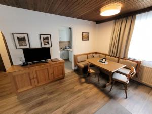 a waiting room with a table and a television at Apartment Top 5 by Interhome in Ischgl