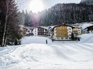 a person is skiing down a snow covered slope at Apartment Top 5 by Interhome in Ischgl