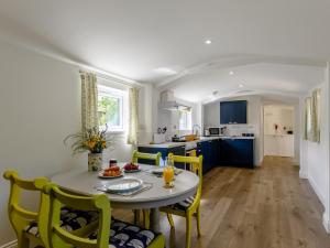 a kitchen and dining room with a table and chairs at 1 Bed in Weymouth 78865 in Weymouth
