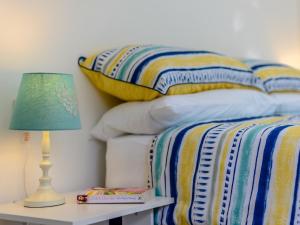 a bed with a lamp on a table next to a bed at 1 Bed in Weymouth 78865 in Weymouth