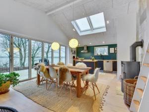 a kitchen and dining room with a table and chairs at Holiday Home Lika - 25m to the inlet in SE Jutland by Interhome in Nordborg