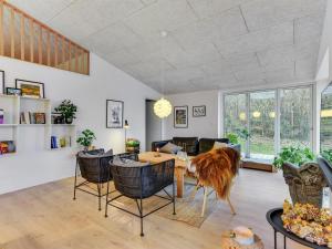 a living room with a table and chairs at Holiday Home Lika - 25m to the inlet in SE Jutland by Interhome in Nordborg