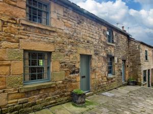 an old stone building with a door and windows at 2 Bed in Longnor 78661 in Longnor