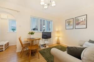 a living room with a couch and a table at Stylish short-term let in Bucks in Loudwater