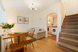 a living room and dining room with a table and a kitchen at Stylish short-term let in Bucks in Loudwater