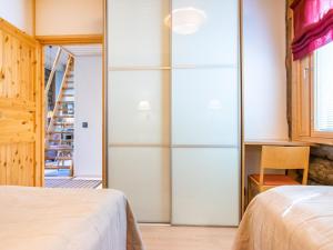 1 dormitorio con 2 camas y pared de cristal en Holiday Home Nilikuru e 12 by Interhome, en Saariselkä