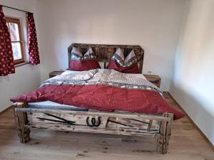 a bed with a wooden frame in a room at Apartment Mühltalschmiede by Interhome in Dorf