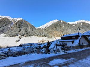 a building in the snow with mountains in the background at Apartment Top 7 by Interhome in Ischgl