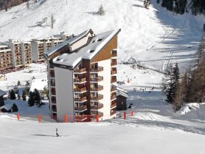 a building on a ski slope in the snow at Apartment Mont-Fort 26 by Interhome in Siviez