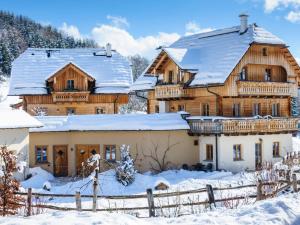 a large wooden house covered in snow at Holiday Home st martin chalets-2 by Interhome in Sankt Martin