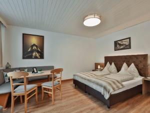 a bedroom with a bed and a table and chairs at Apartment Studio 1 by Interhome in Ischgl +26 photos
