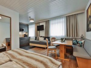 a living room with a couch and a table at Apartment Studio 1 by Interhome in Ischgl