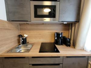 a kitchen with a sink and a microwave at Apartment Studio 1 by Interhome in Ischgl