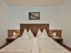 a bedroom with a bed with two side tables at Apartment Studio 1 by Interhome in Ischgl