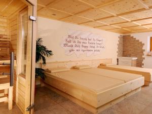a bedroom with a bed with a writing on the wall at Holiday Home Pfundshof by Interhome in Hippach