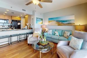 a living room with a couch and a table at Sterling Breeze 1803 in Panama City Beach
