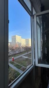 a window of a building with a view of a city at Квартира посуточно in Almaty