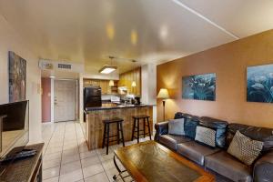 a living room with a couch and a kitchen at Gulfview I #312 in South Padre Island